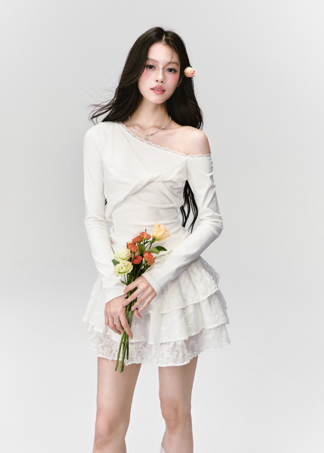 Fragileheart off-shoulder top, white lace blouse, asymmetric draped shirt, luxury Korean fashion, elegant feminine outfit, quiet luxury style, pastel noir aesthetic, winter 2025 collection, modern romantic fashion, ivory one-shoulder knit, soft lace trim top, minimalist luxury wear, Korean chic fashion, delicate off-shoulder blouse
