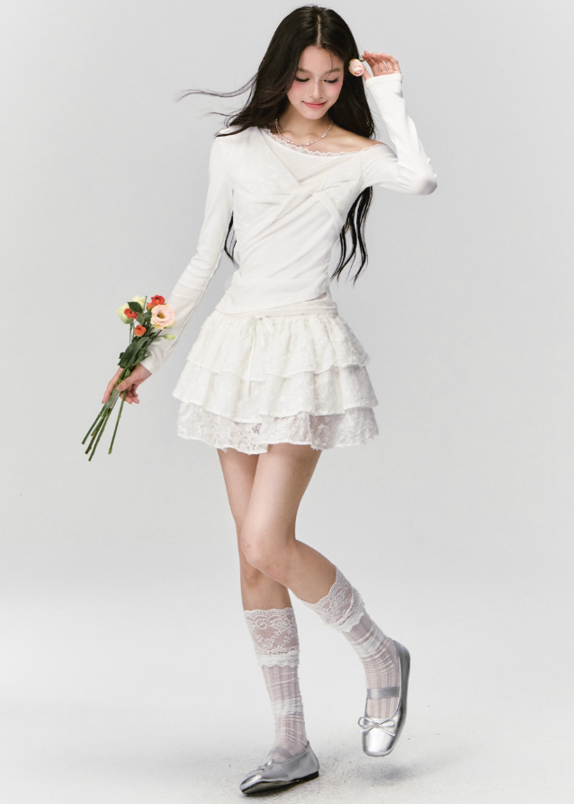 Fragileheart off-shoulder top, white lace blouse, asymmetric draped shirt, luxury Korean fashion, elegant feminine outfit, quiet luxury style, pastel noir aesthetic, winter 2025 collection, modern romantic fashion, ivory one-shoulder knit, soft lace trim top, minimalist luxury wear, Korean chic fashion, delicate off-shoulder blouse
