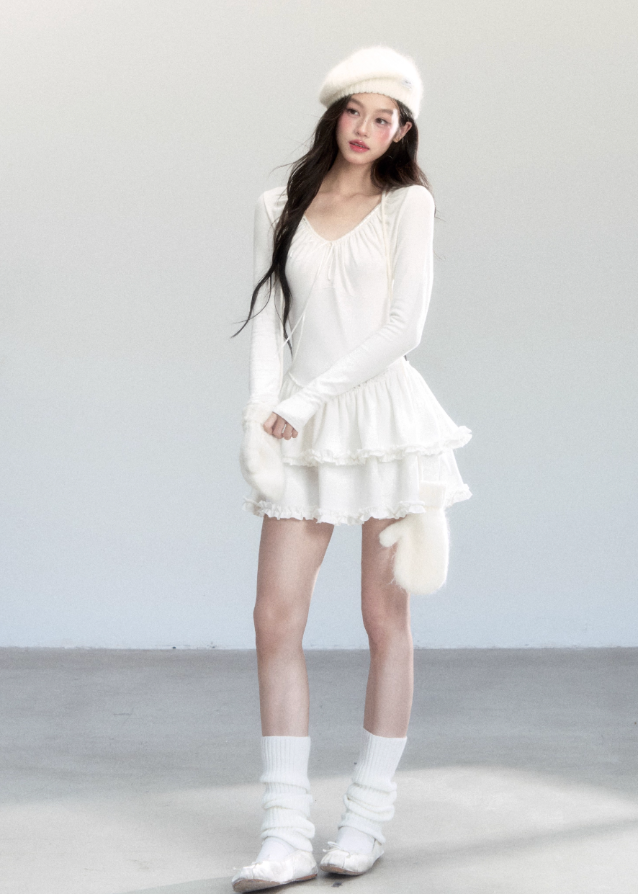 Fragileheart knit dress, ballet style outfit, ivory ruffle one-piece, luxury Korean fashion, quiet luxury womenswear, pastel noir aesthetic, elegant autumn dress, V-neck knit outfit, pre-autumn K-fashion, romantic feminine style, tiered ruffle skirt, soft Korean fashion, delicate white dress, graceful knit one-piece
