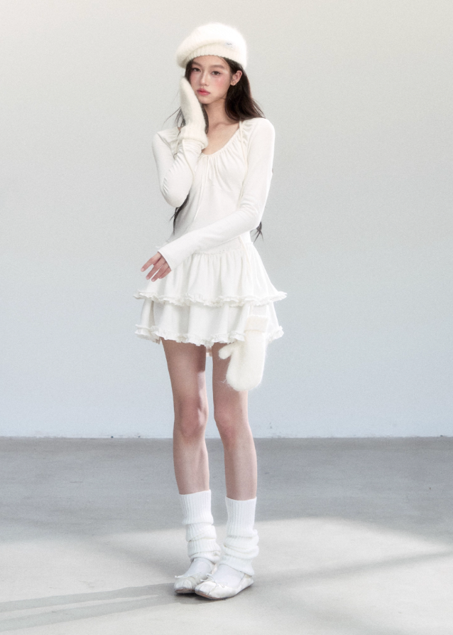 Fragileheart knit dress, ballet style outfit, ivory ruffle one-piece, luxury Korean fashion, quiet luxury womenswear, pastel noir aesthetic, elegant autumn dress, V-neck knit outfit, pre-autumn K-fashion, romantic feminine style, tiered ruffle skirt, soft Korean fashion, delicate white dress, graceful knit one-piece
