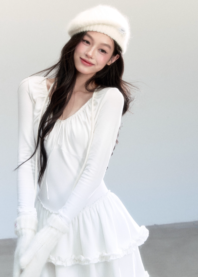 Fragileheart knit dress, ballet style outfit, ivory ruffle one-piece, luxury Korean fashion, quiet luxury womenswear, pastel noir aesthetic, elegant autumn dress, V-neck knit outfit, pre-autumn K-fashion, romantic feminine style, tiered ruffle skirt, soft Korean fashion, delicate white dress, graceful knit one-piece
