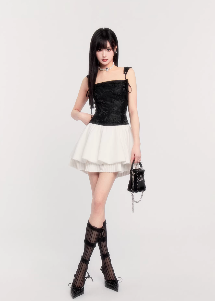 suspender mini dress women, corset waist dress, pleated puff skirt dress, edgy princess style dress, black white mini dress, vock dress style, waist slimming party dress, alternative fashion mini dress, structured suspender dress, dark romantic fashion, statement birthday dress women, controlled silhouette clothing, modern gothic mini dress, edgy valentine dress women, fashion puff skirt dress