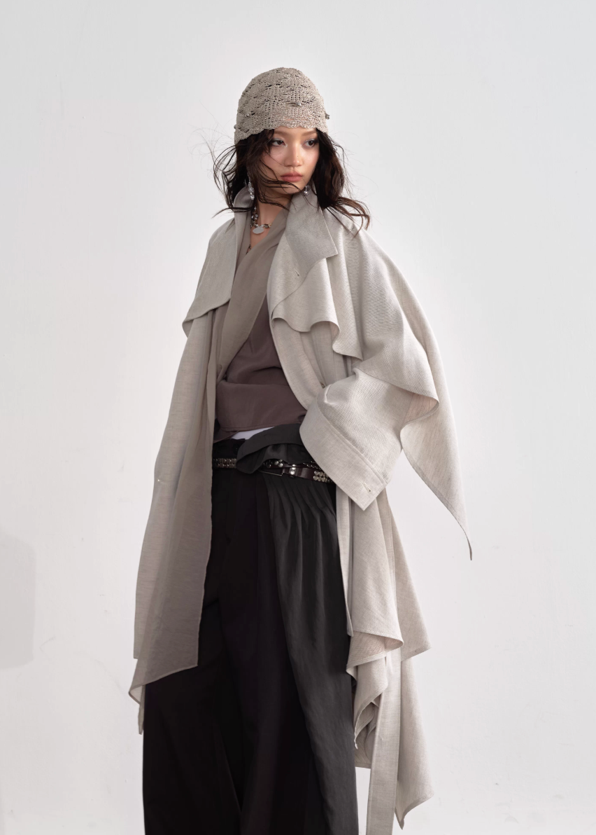 JNYLON detachable cape trench coat women, Korean stylish linen trench coat, modern Korean fashion long coat, chic natural style outerwear women, trendy Korean street chic trench, plaster white irregular trench coat, oversized linen blend coat Korean style, urban fashion layered trench women, stylish Korean aesthetic long coat, fashionable natural tone trench coat