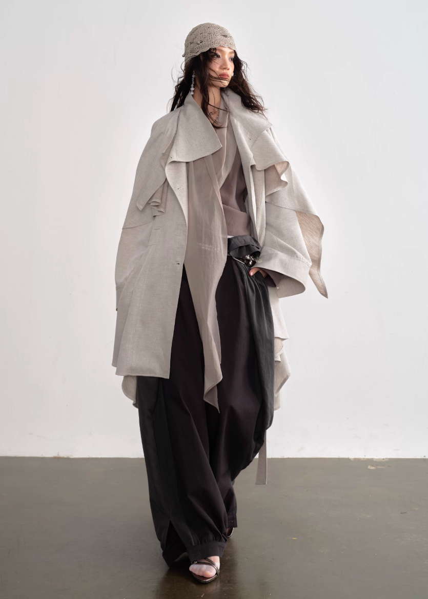 JNYLON detachable cape trench coat women, Korean stylish linen trench coat, modern Korean fashion long coat, chic natural style outerwear women, trendy Korean street chic trench, plaster white irregular trench coat, oversized linen blend coat Korean style, urban fashion layered trench women, stylish Korean aesthetic long coat, fashionable natural tone trench coat