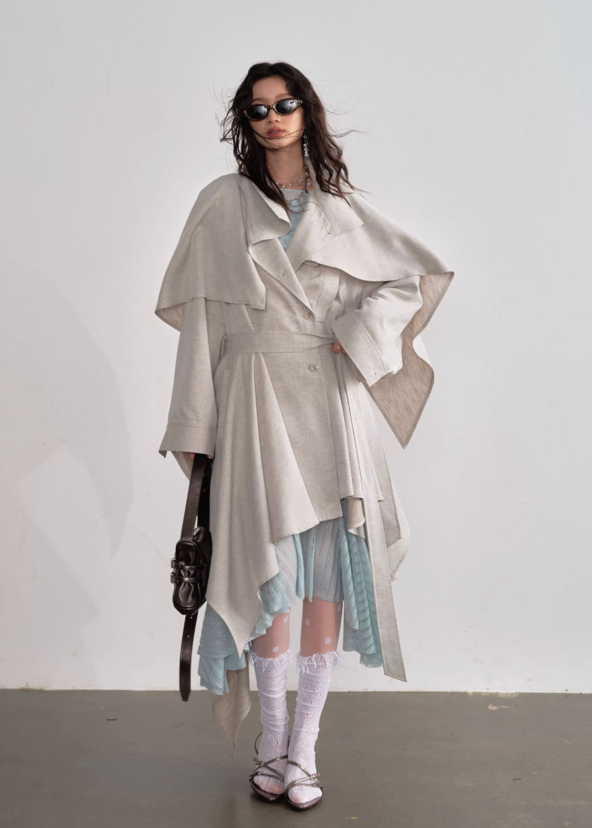 JNYLON detachable cape trench coat women, Korean stylish linen trench coat, modern Korean fashion long coat, chic natural style outerwear women, trendy Korean street chic trench, plaster white irregular trench coat, oversized linen blend coat Korean style, urban fashion layered trench women, stylish Korean aesthetic long coat, fashionable natural tone trench coat