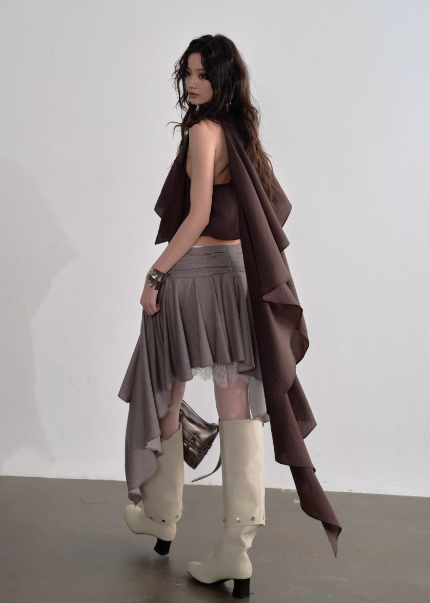 JNYLON pleated linen skirt women, Korean stylish asymmetric skirt, modern Korean fashion layered skirt, chic retro romantic pleated skirt women, trendy Korean street chic outfit, linen blend irregular skirt Korean style, lightweight pleated fashion skirt women, urban fashion asymmetric skirt, stylish Korean aesthetic skirt, fashionable natural tone pleated skirt