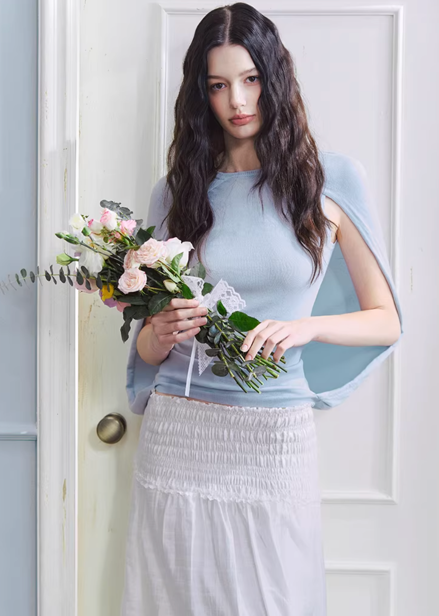lyocell knit top, cape style top women, sleeveless knit top, korean fashion top, minimalist summer top, draped knit top, lightweight knitwear, breathable fabric top, modern feminine clothing, casual elegant top, soft knit blouse, parisian style clothing, versatile summer outfit, aesthetic fashion top, refined casual wear, clean line top women, flowy knit top, chic everyday top, simple design top, comfortable summer knit