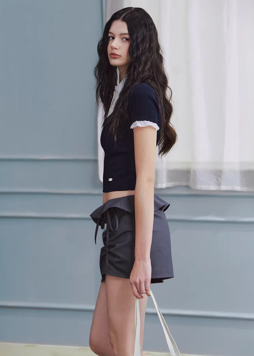 layered knit top women, fake two piece top, shirt collar knit, korean fashion top, spring outfit ideas, slim fit knit top, short sleeve knit women, feminine casual top, lightweight knitwear, aesthetic fashion top, modern feminine clothing, versatile everyday top, parisian style clothing, fitted knit blouse, clean line top, refined casual wear, minimal style top, chic everyday outfit, spring wardrobe essential, contrast collar top