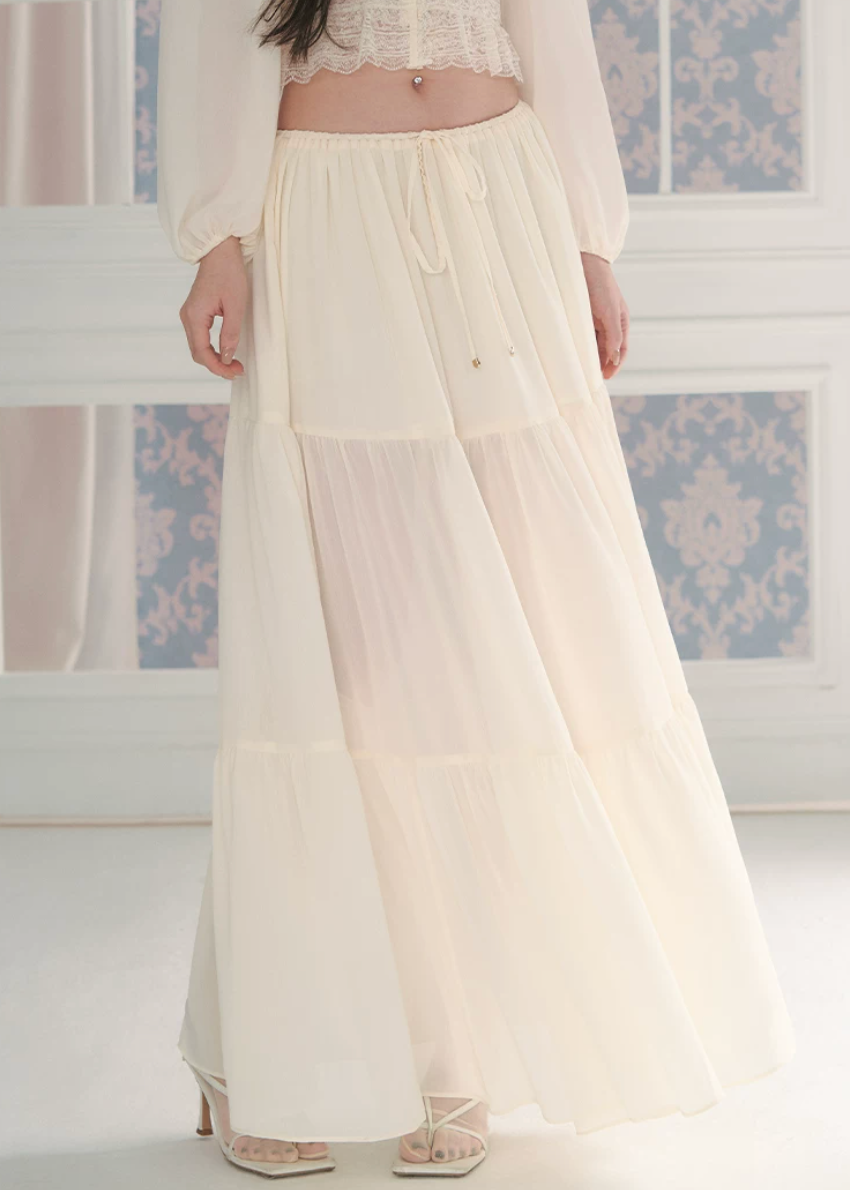 chiffon cake skirt, low rise maxi skirt, resort style skirt, tiered chiffon skirt, feminine Korean skirt, romantic summer skirt, draped long skirt, beach vacation skirt, airy summer skirt, soft chiffon maxi skirt, elegant resort outfit, flowing tiered skirt, Korean feminine fashion, vacation ready skirt, lightweight long skirt