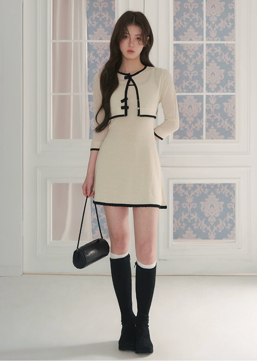 short sleeve knit cardigan, cropped knit cardigan, bow closure cardigan, asymmetric cardigan, cream knit cardigan, French style cardigan, Korean feminine cardigan, contrast trim cardigan, soft knit top, summer layering cardigan, romantic knit cardigan, feminine Korean fashion, vintage inspired cardigan, cream bow cardigan, lightweight knit cardigan