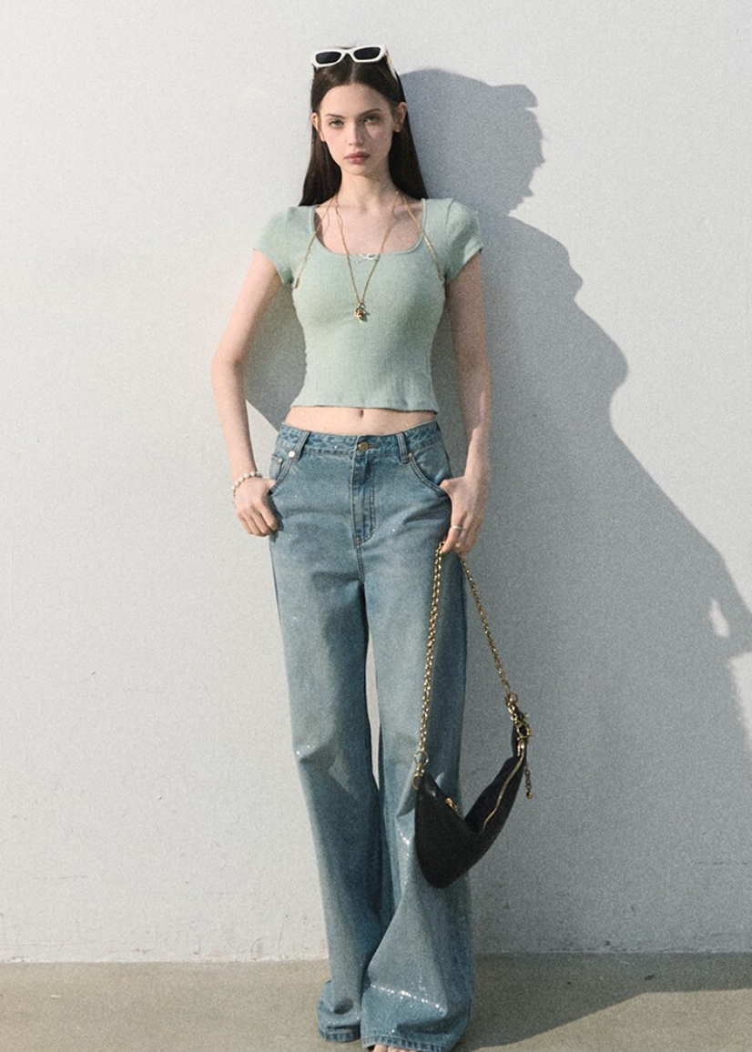 Textured short-sleeve top styled with wide-leg denim