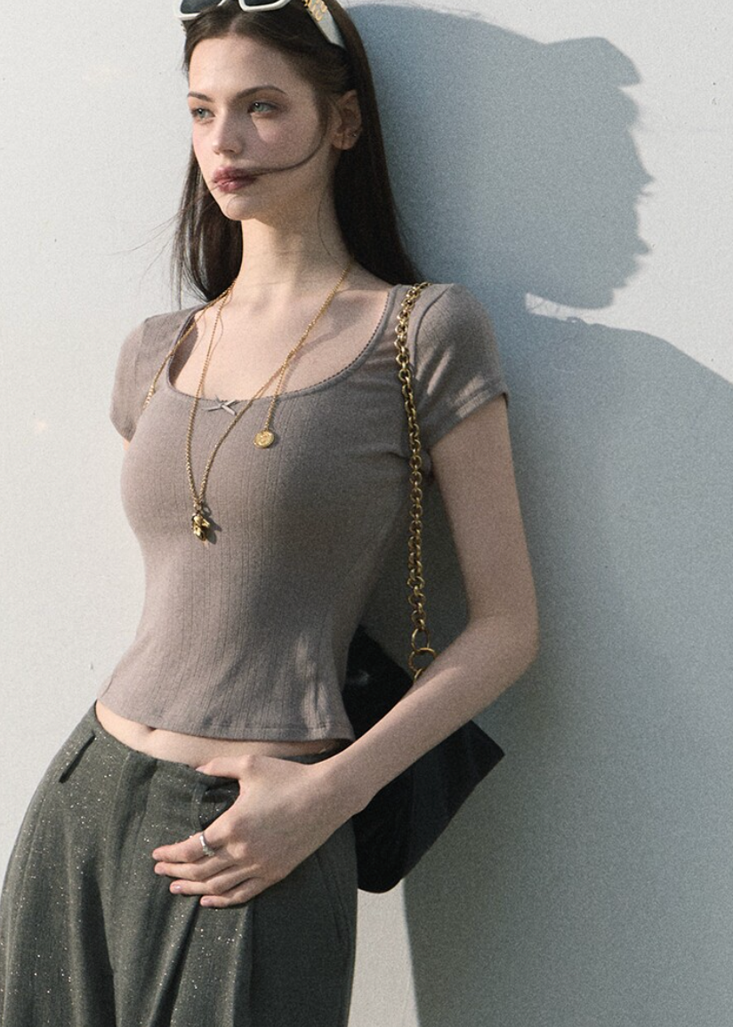 Model wearing a lace-trim cropped tee with relaxed jeans