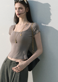Model wearing a lace-trim cropped tee with relaxed jeans