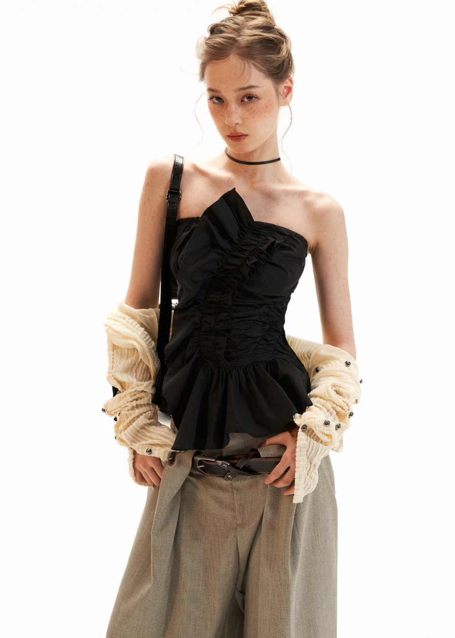 Y2K bandeau top styled with a pleated skirt