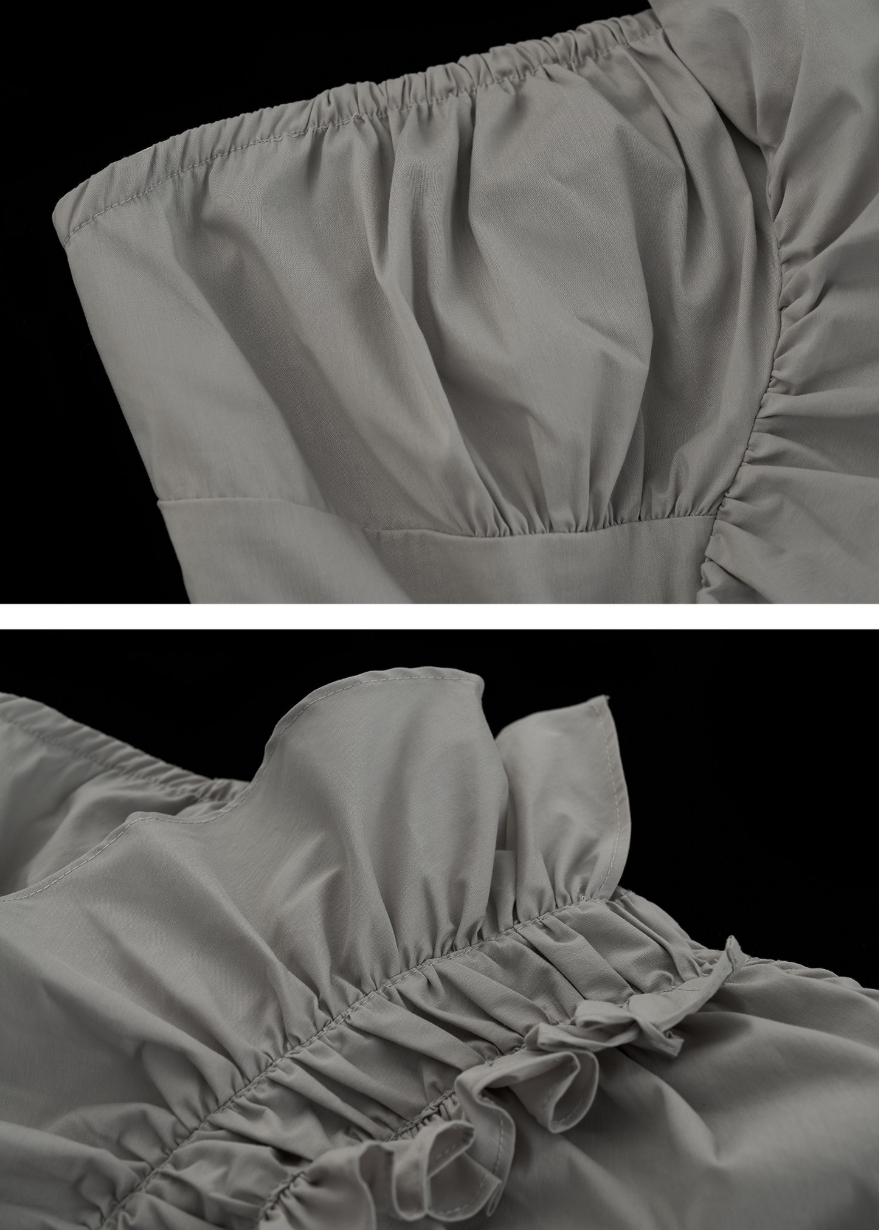 Y2K bandeau top styled with a pleated skirt