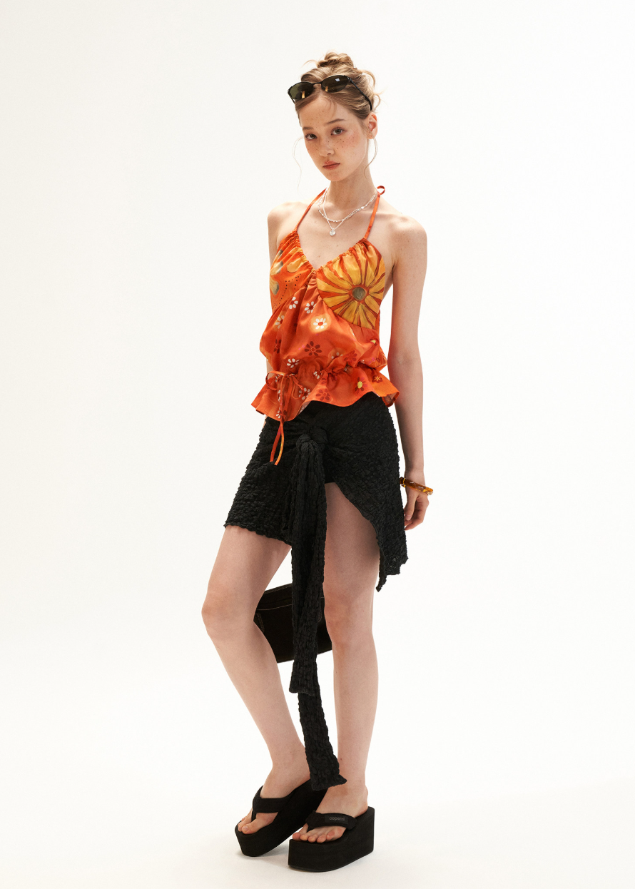 Warm orange drawstring halter top styled with lace shorts