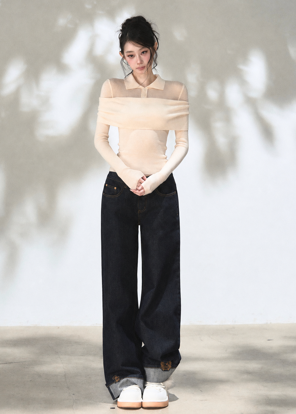 Ivory off-shoulder knit top with elegant draped neckline