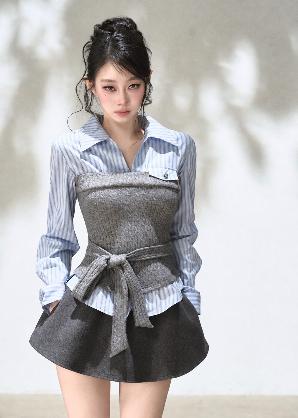 Blue striped shirt with grey textured knit corset overlay and waist tie