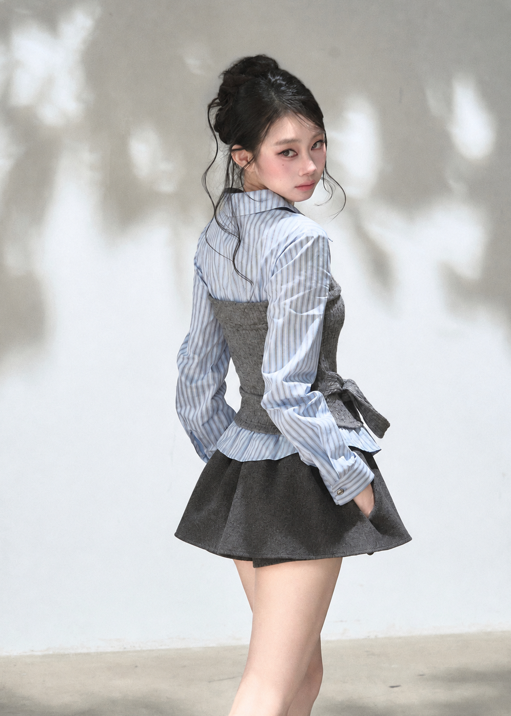 Blue striped shirt with grey textured knit corset overlay and waist tie
