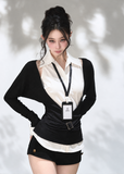 Black V-neck knit top layered over a white sleeveless collared shirt