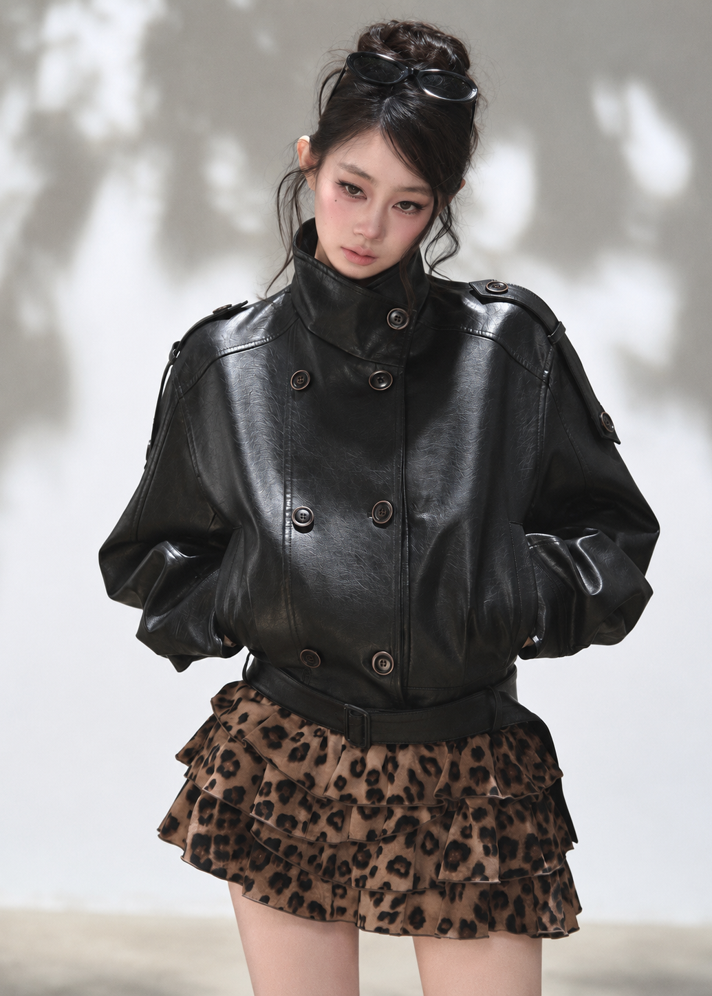 Cropped black faux leather jacket with voluminous sleeves and wide shoulders