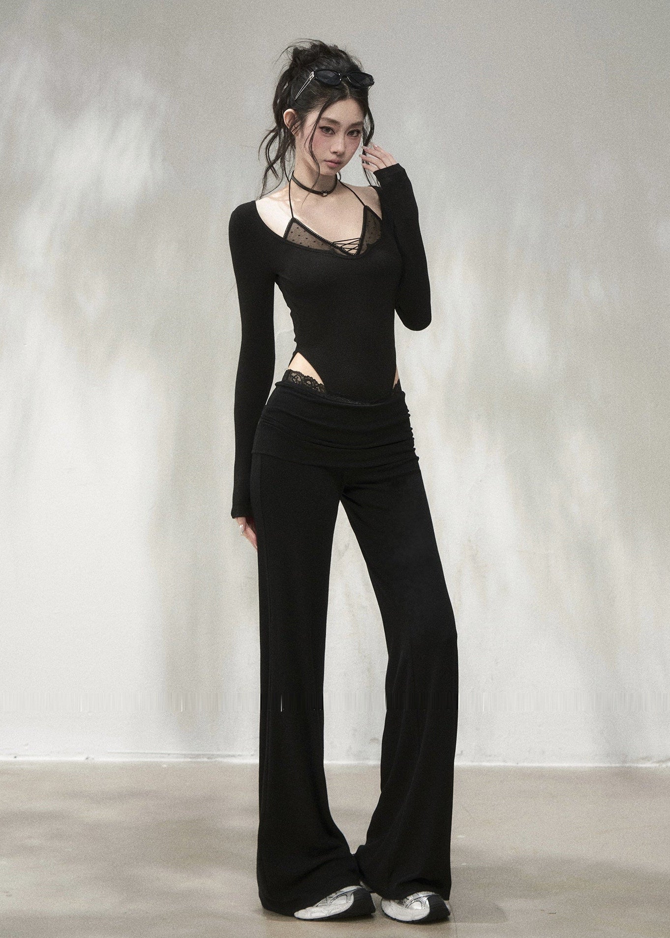 Black lace waistband flare pants with elegant draped silhouette