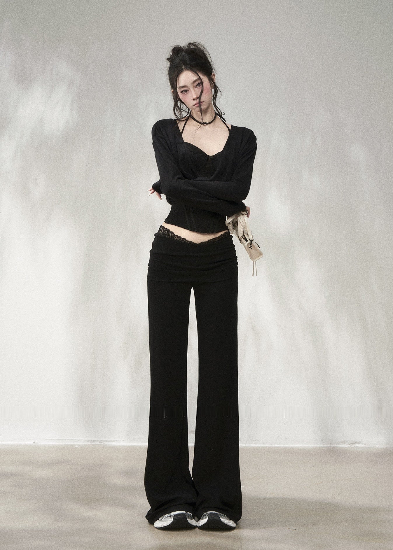 Black lace waistband flare pants with elegant draped silhouette