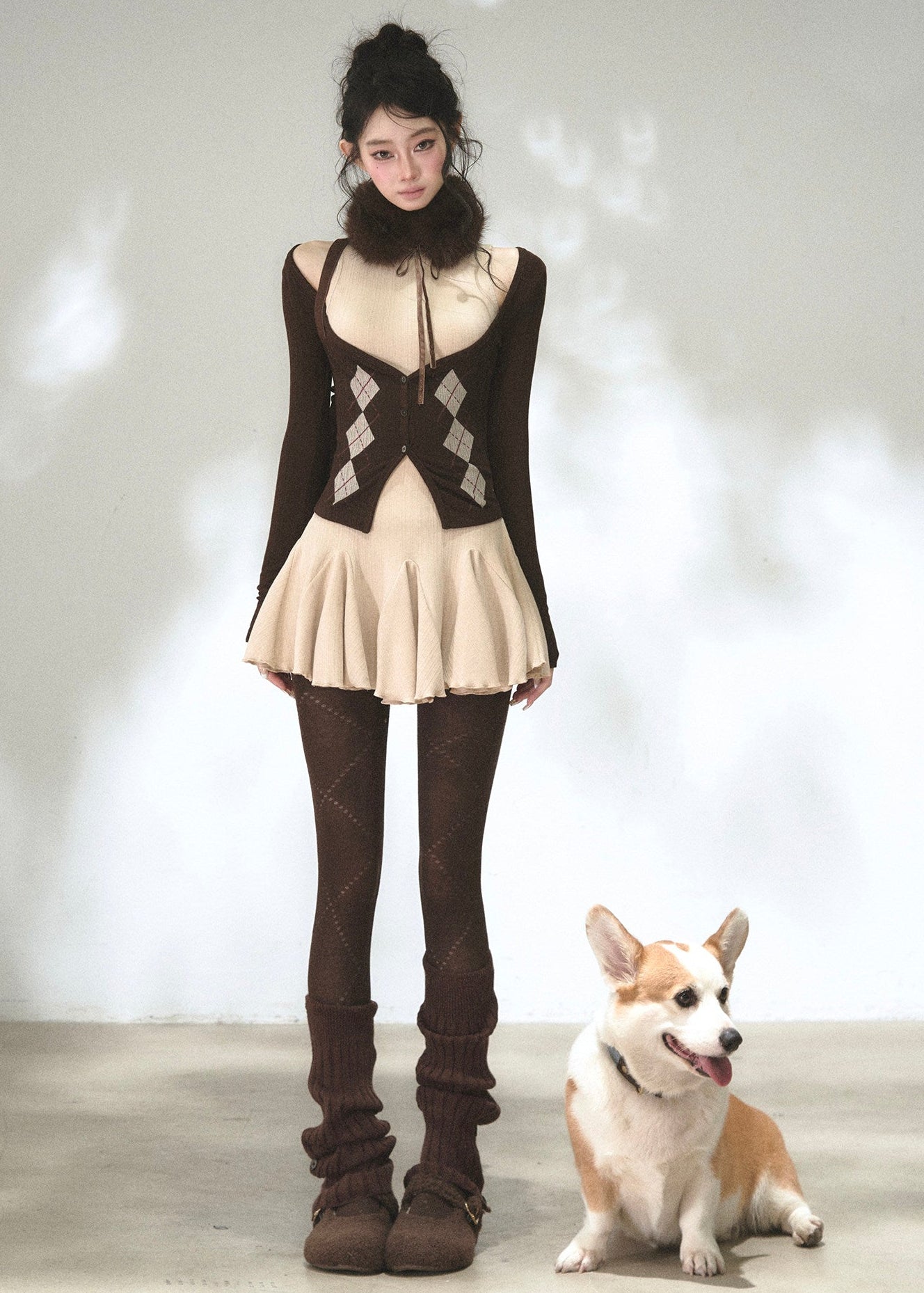 Brown cold-shoulder cardigan layered over a beige flared knit dress
