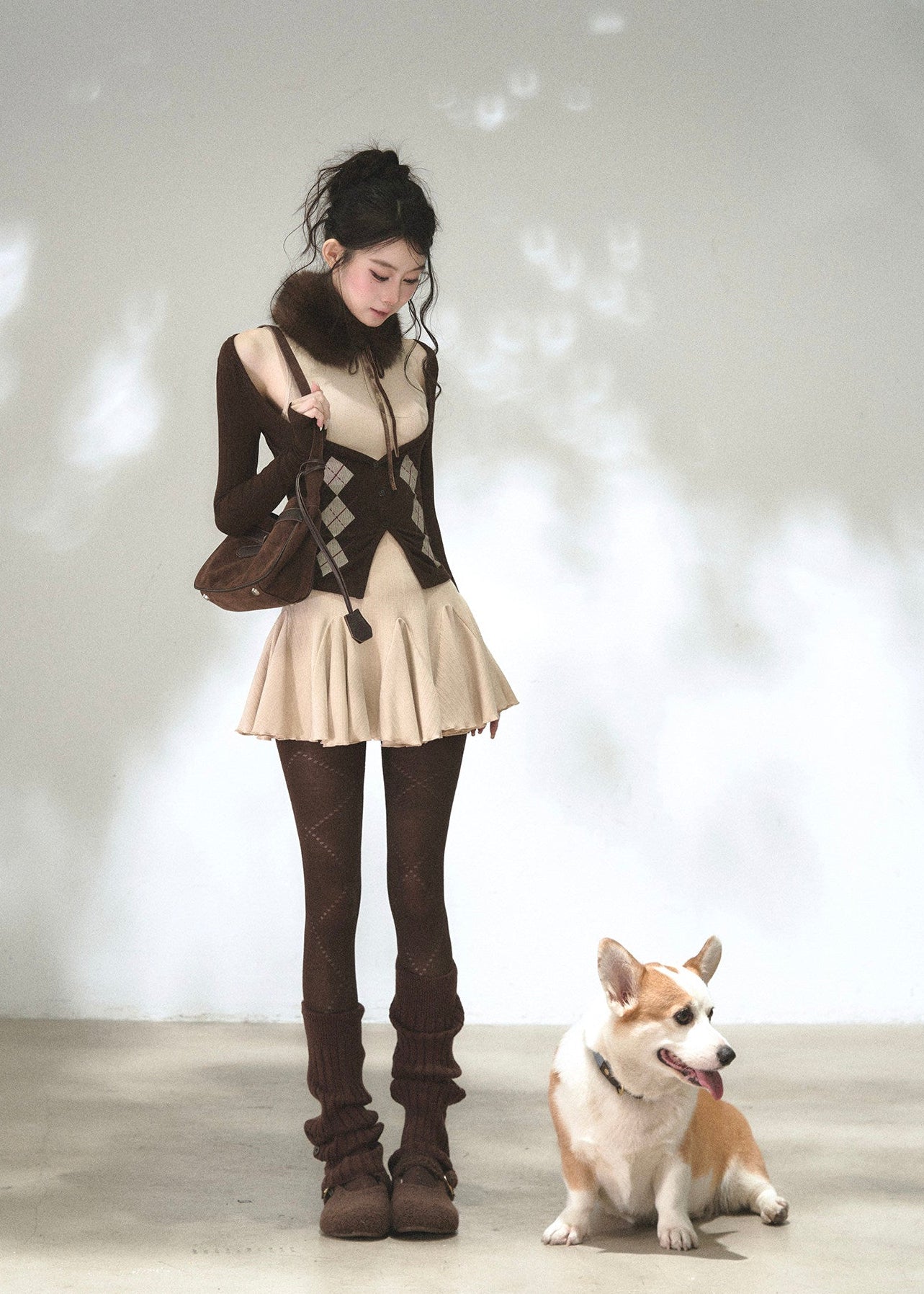 Brown cold-shoulder cardigan layered over a beige flared knit dress