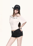 White script print top styled with boots and a cap