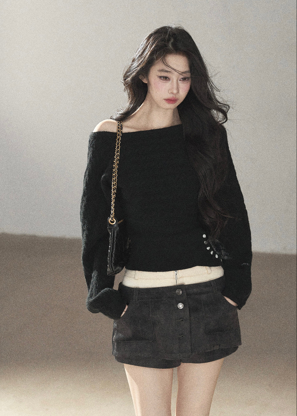 Black asymmetric off-shoulder cable knit sweater with long sleeves