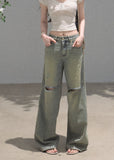 Faded green wide-leg jeans with distressed knee openings