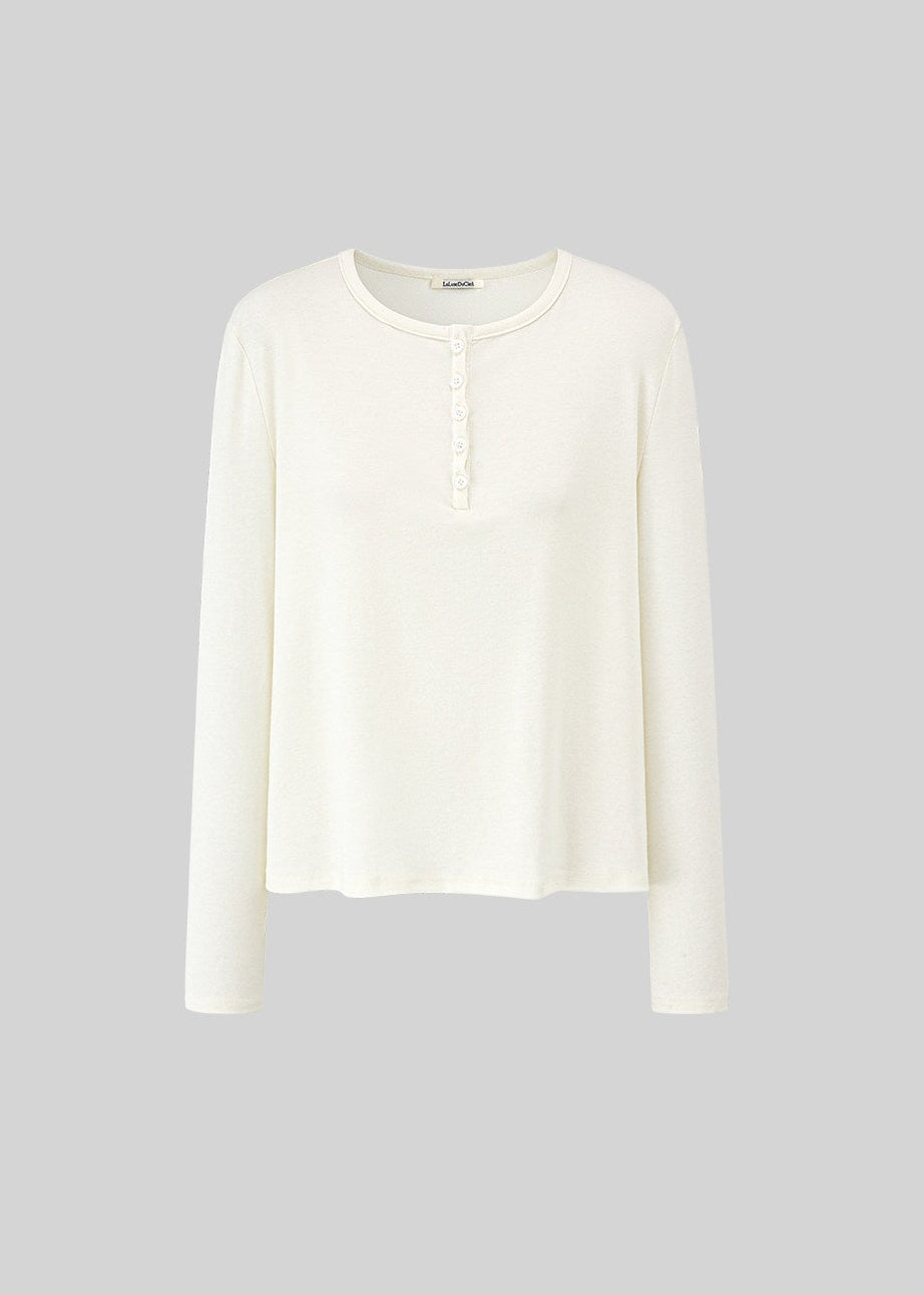 Model wearing a Tencel-wool Henley long-sleeve top