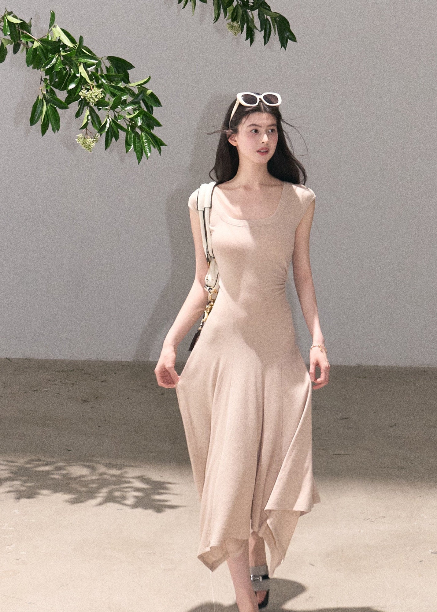 Minimal sleeveless dress with irregular flowing hem