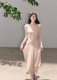 Minimal sleeveless dress with irregular flowing hem