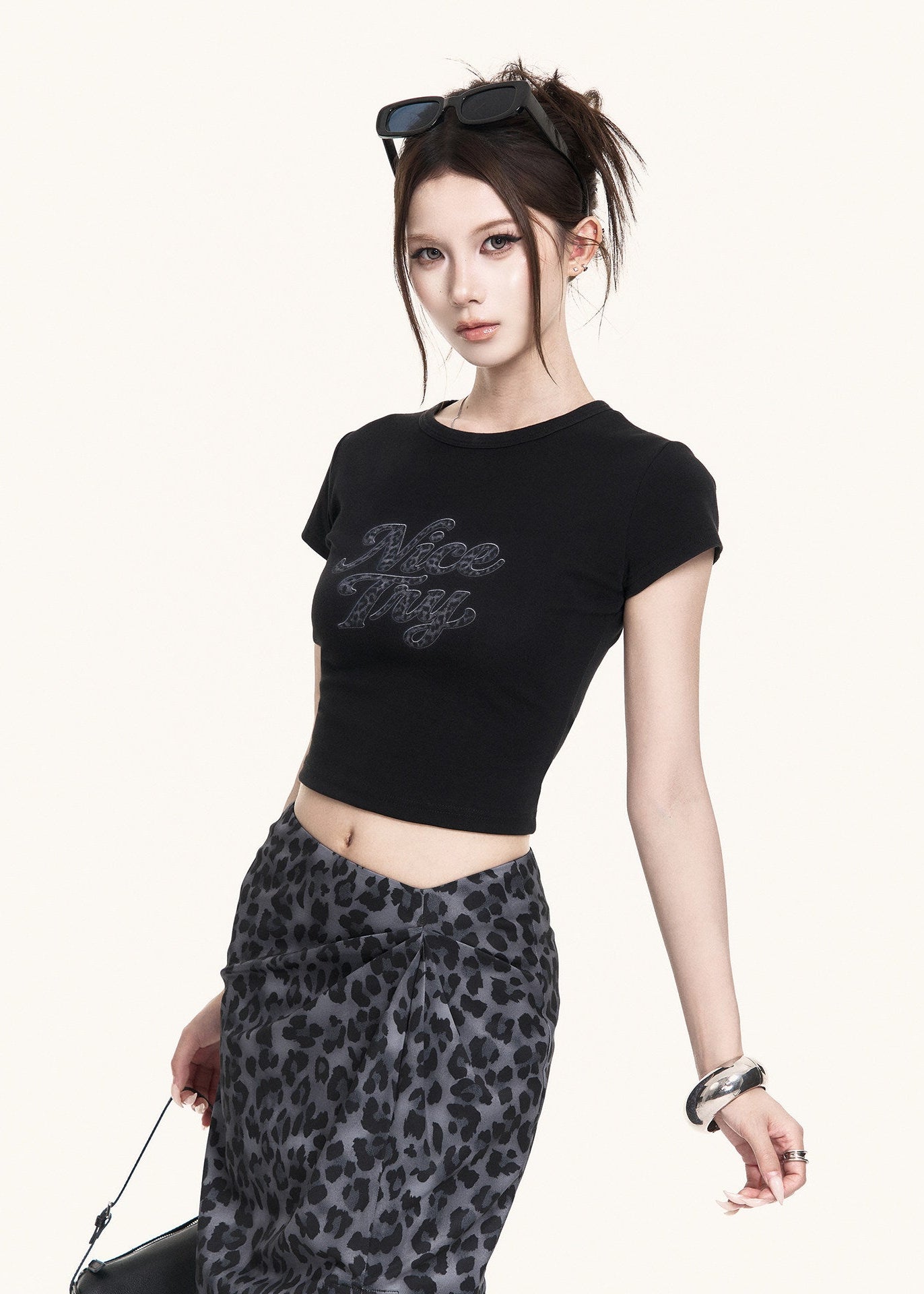 Fitted black short-sleeve tee styled with a leopard skirt