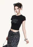 Fitted black short-sleeve tee styled with a leopard skirt