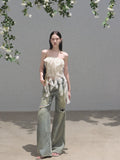 Faded green wide-leg jeans with distressed knee openings