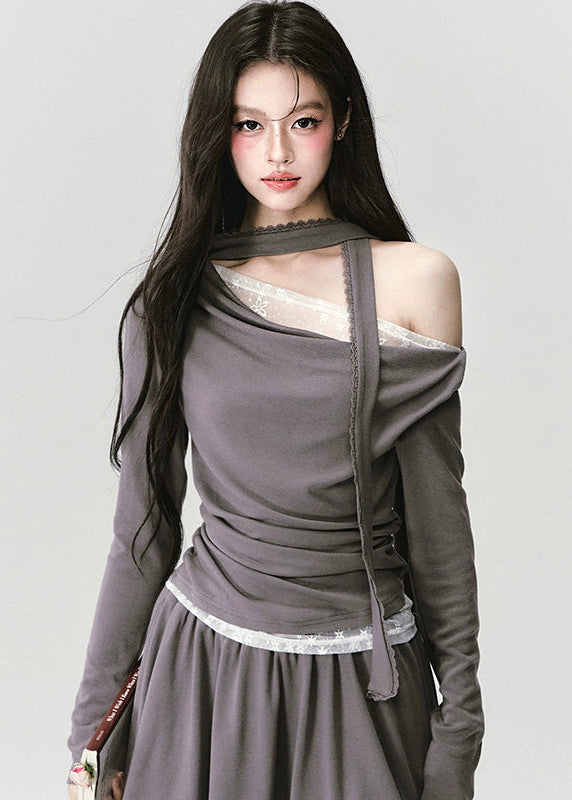 The Migratory Lace Sonata Set drapes the body in Fragileheart’s signature melancholy elegance. A soft ashen knit wraps asymmetrically over lace, revealing just enough fragility beneath structure. Paired with a flowing skirt trimmed in translucent lace, it moves like twilight — graceful, introspective, and quietly magnetic.