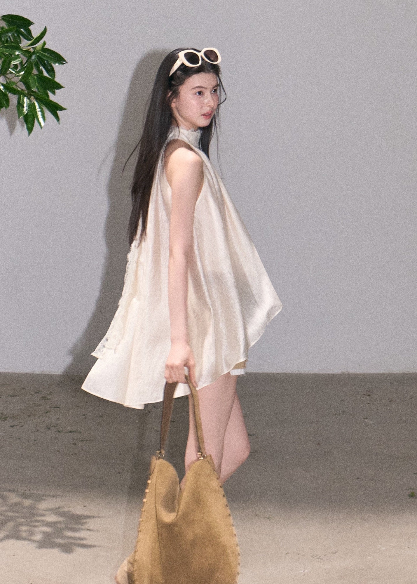 Sleeveless A-line top with soft asymmetric drape