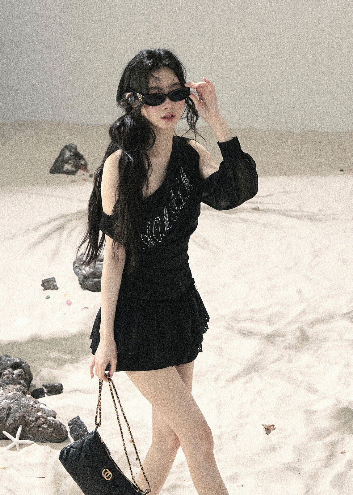 Black off-shoulder mesh top with ruched fit and sheer long sleeve