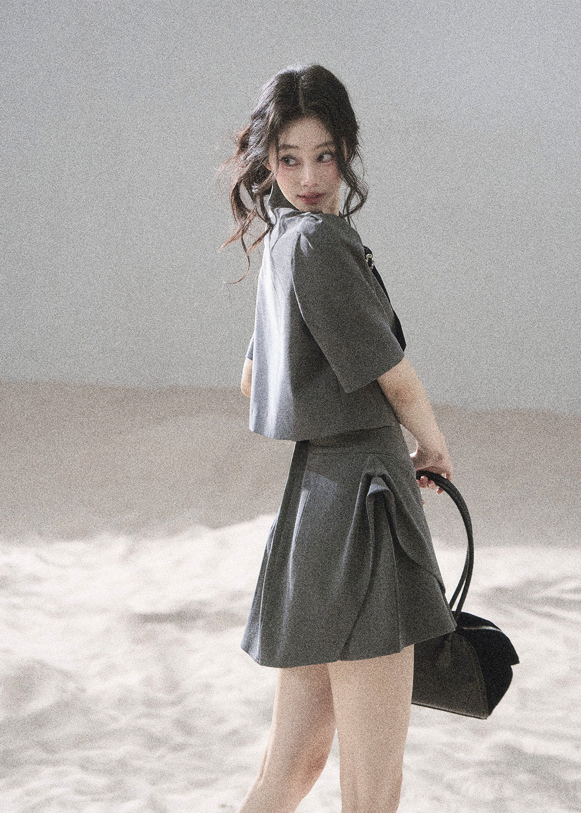 Gray tailored blazer skirt set with softly structured shoulders