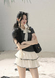 Gray fitted short-sleeve top with ivory lace bow neckline