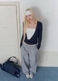 Model wearing gray plaid wide-leg pants with vintage lace waist detailing