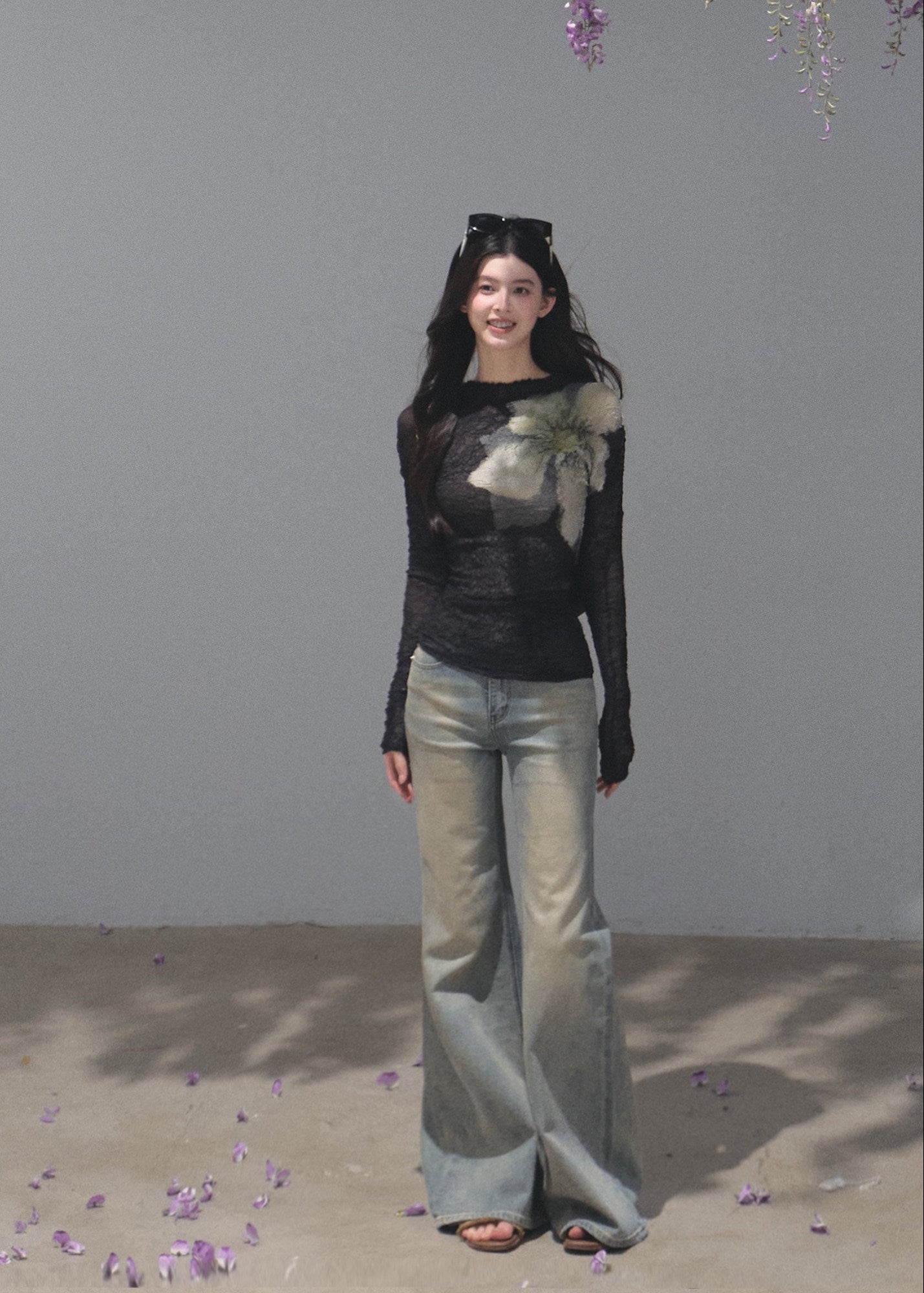Model wearing a black botanical-print long-sleeve base layer