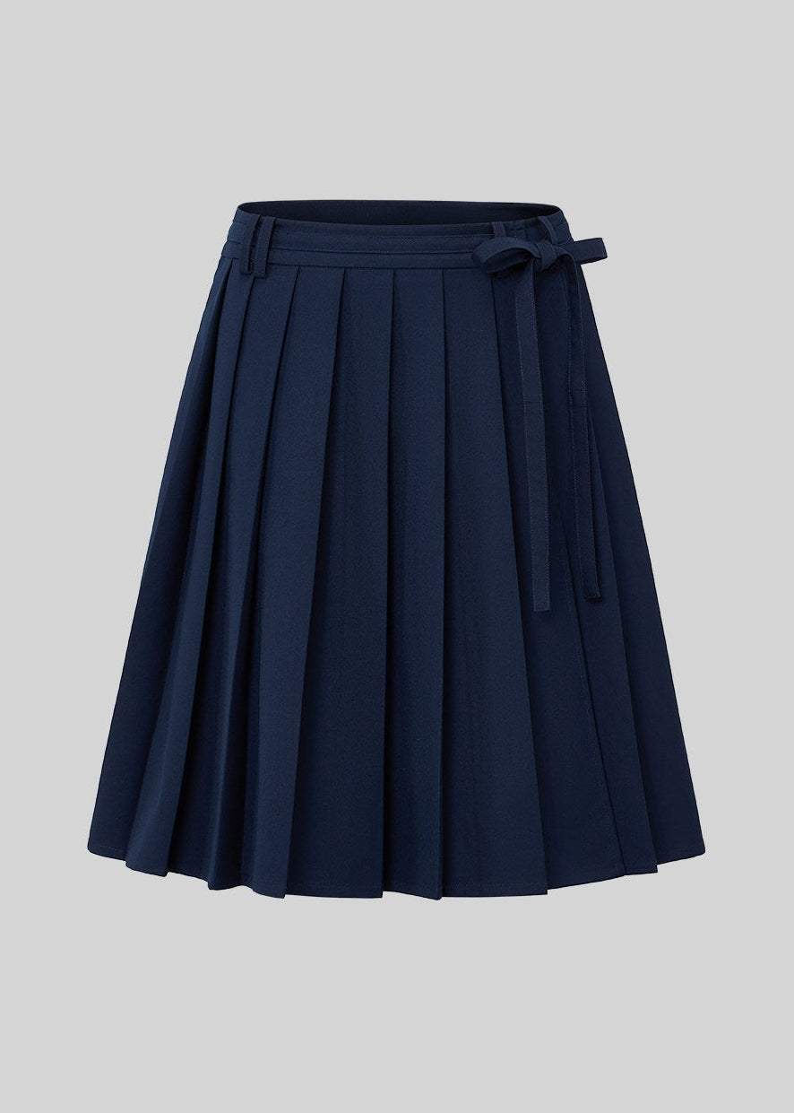 Front view of a navy skirt with broad pleats and a belted waistband