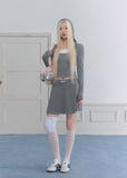 Gray hooded waist-cinching top with a coordinating pleated mini skirt