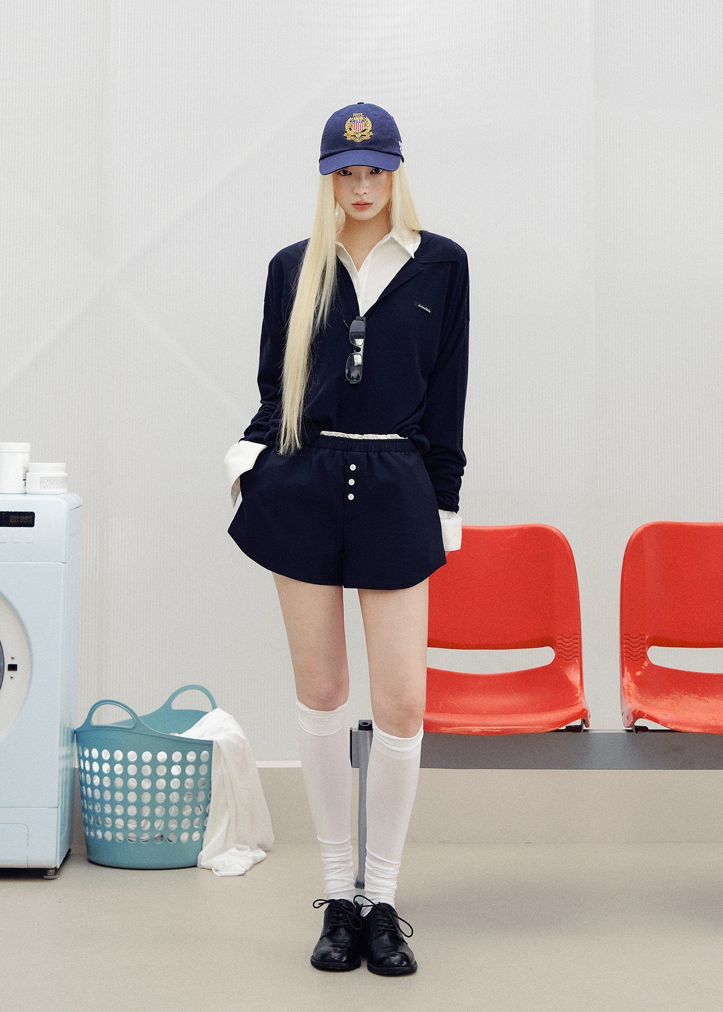 Navy cotton shorts with a contrasting light waistband and small white front buttons