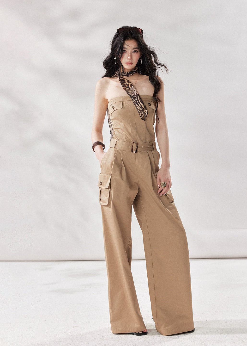 cargo jumpsuit women, strapless jumpsuit women, bandeau jumpsuit, utility jumpsuit women, wide leg jumpsuit women, summer jumpsuit outfit women, beige jumpsuit women, modern minimal outfit women, street style jumpsuit women, fashion forward jumpsuit, elevated casual outfit women, one piece outfit women, trendy cargo outfit women, chic summer jumpsuit, stylish utility outfit