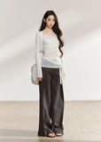 White asymmetric layered long-sleeve top with sheer panels and draped waist ties